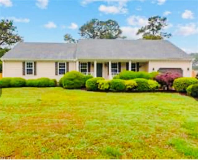 single story home featuring a front yard and a garage