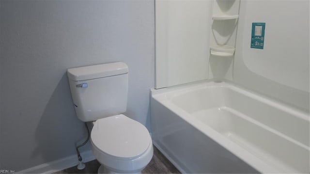 bathroom featuring toilet and a tub