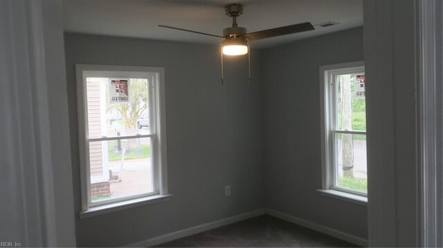 unfurnished room featuring ceiling fan, carpet floors, and a healthy amount of sunlight