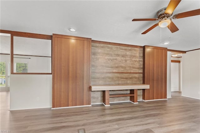 unfurnished living room featuring ceiling fan and hardwood / wood-style floors