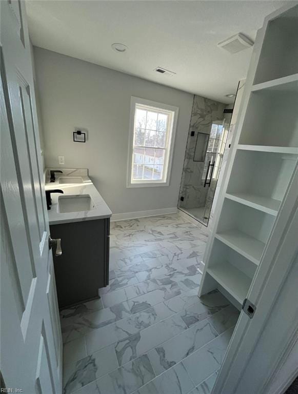 bathroom featuring vanity and a shower with door