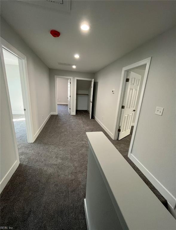 hallway with dark carpet