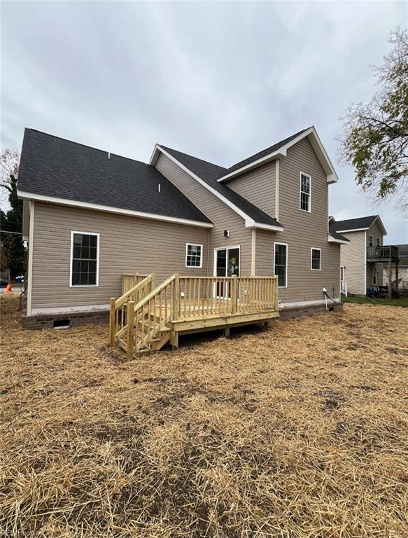 back of property featuring a wooden deck