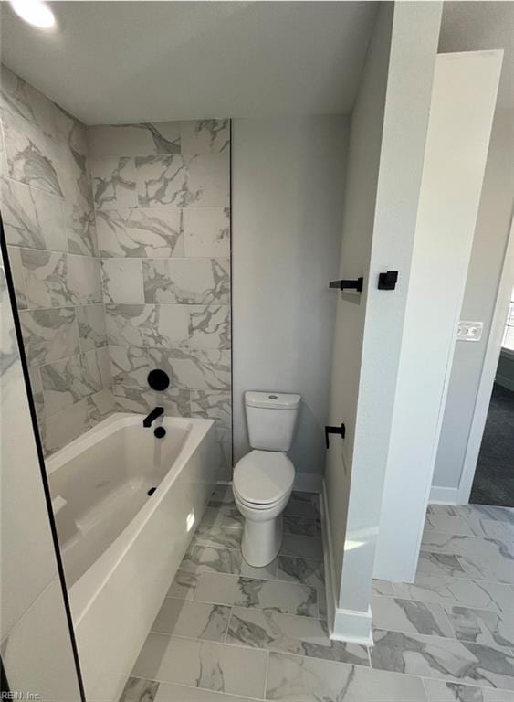 bathroom with bathtub / shower combination and toilet