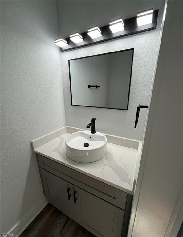 bathroom with vanity and hardwood / wood-style flooring