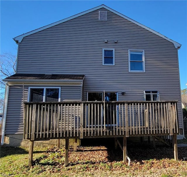 rear view of house featuring a wooden deck