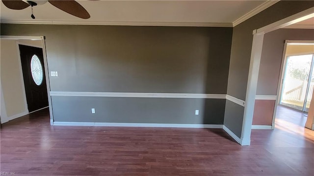 interior space featuring dark wood-type flooring, ceiling fan, and ornamental molding