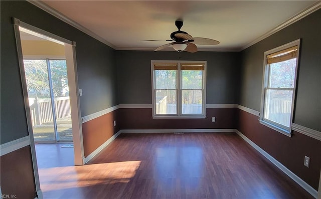 spare room featuring a wealth of natural light, crown molding, ceiling fan, and dark hardwood / wood-style floors