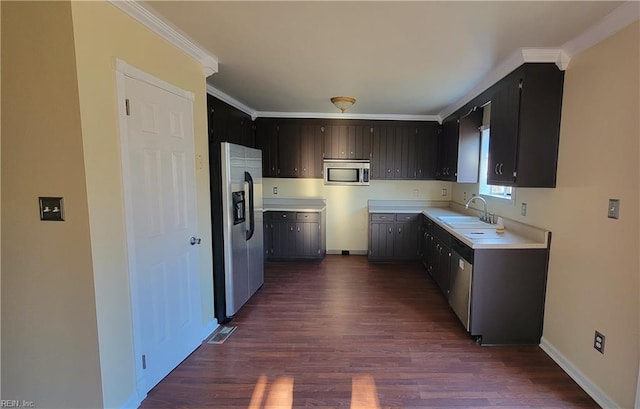 kitchen with crown molding, sink, dark hardwood / wood-style floors, and appliances with stainless steel finishes