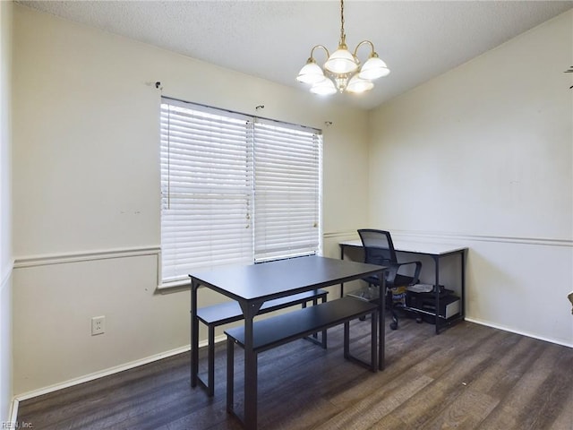 home office featuring an inviting chandelier and dark hardwood / wood-style floors