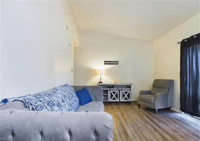 living room featuring vaulted ceiling and wood-type flooring