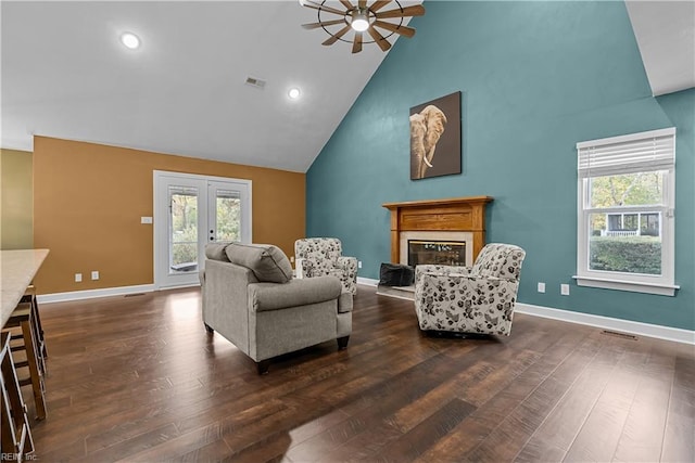 living room featuring ceiling fan, french doors, a healthy amount of sunlight, and dark hardwood / wood-style floors