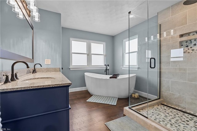 bathroom featuring vanity, independent shower and bath, and a notable chandelier