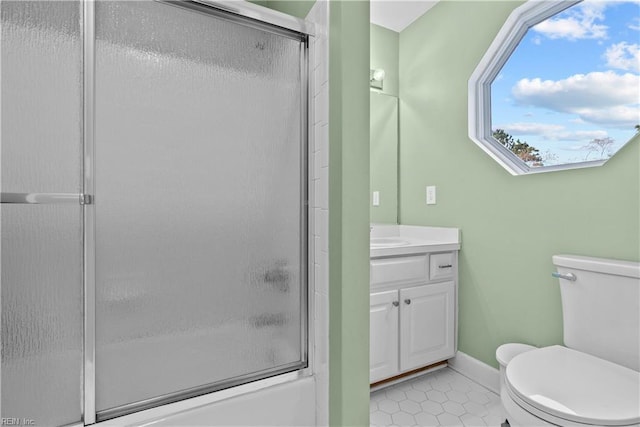 full bathroom with tile patterned flooring, vanity, toilet, and shower / bath combination with glass door