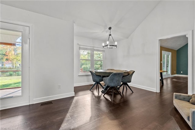 dining area with vaulted ceiling, dark hardwood / wood-style flooring, and a chandelier