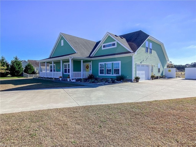 view of front of home with a garage, covered porch, and driveway