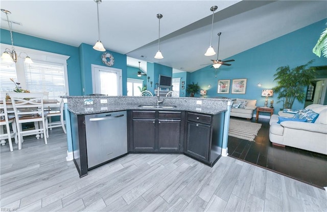 kitchen featuring light wood finished floors, open floor plan, light stone counters, a ceiling fan, and stainless steel dishwasher