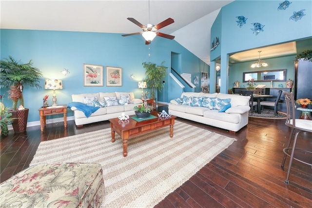 living room with ceiling fan with notable chandelier, dark hardwood / wood-style floors, and lofted ceiling