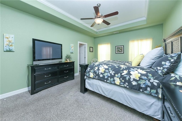 bedroom featuring carpet floors, a tray ceiling, ceiling fan, and crown molding