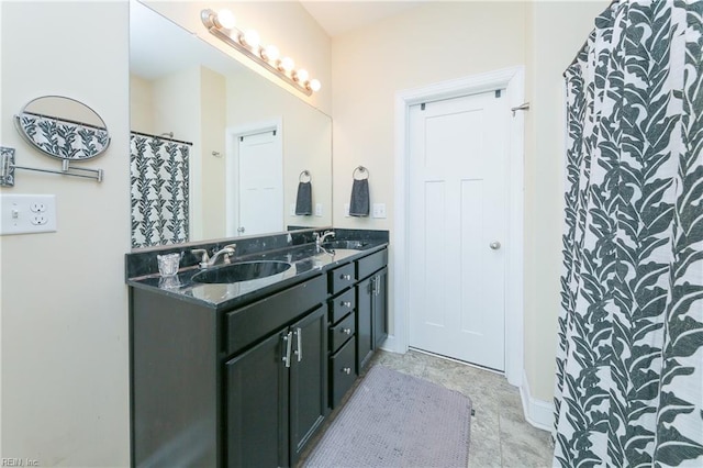 bathroom featuring a sink and double vanity