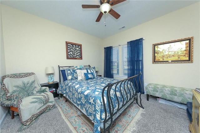 carpeted bedroom featuring visible vents and ceiling fan