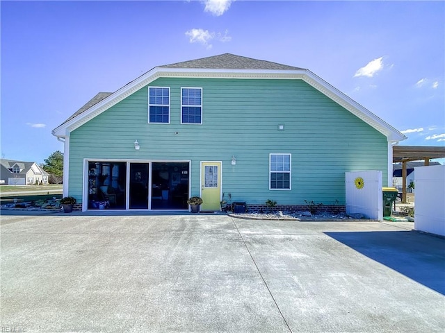 rear view of house with a garage and driveway