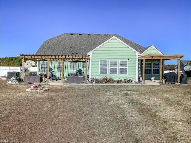 rear view of house with a patio, fence, and a pergola