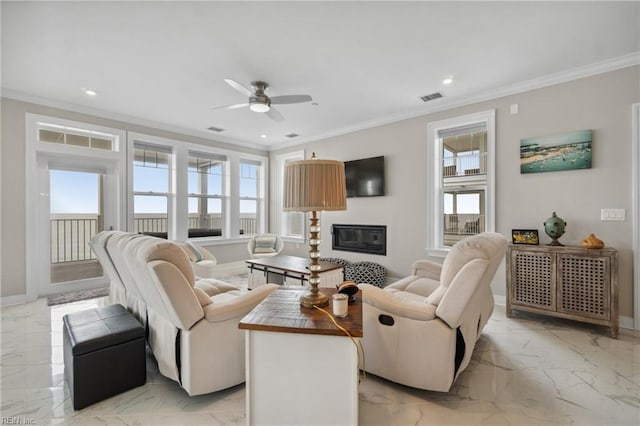 living room featuring ceiling fan and crown molding