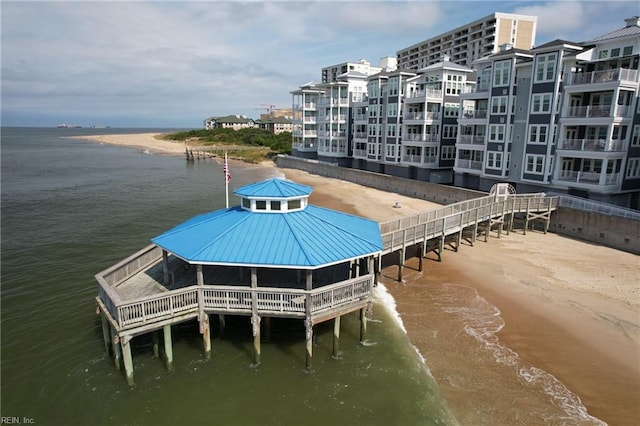 view of dock with a water view and a view of the beach