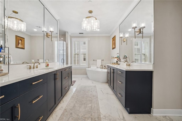 bathroom featuring a bathing tub, vanity, ornamental molding, and a notable chandelier