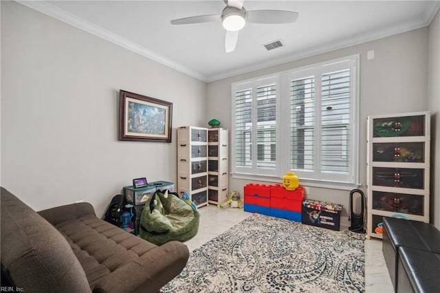 recreation room featuring ceiling fan and ornamental molding