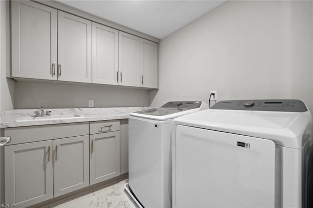 washroom featuring washer and clothes dryer, cabinets, and sink