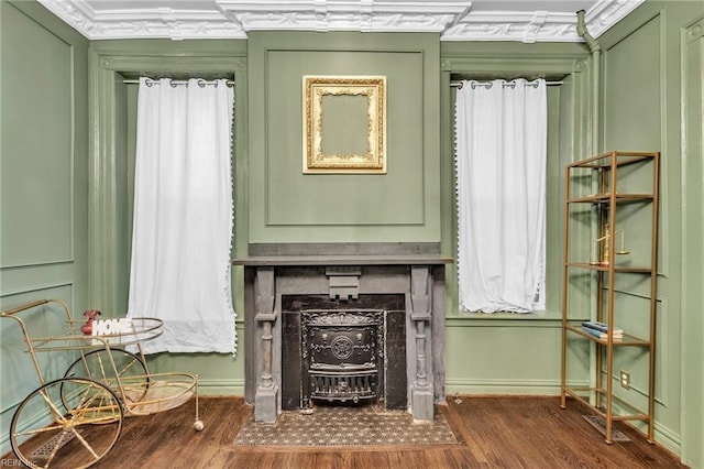 interior space featuring dark hardwood / wood-style floors, a wood stove, and ornamental molding