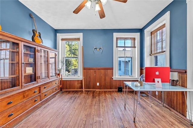 living area featuring light hardwood / wood-style flooring and ceiling fan