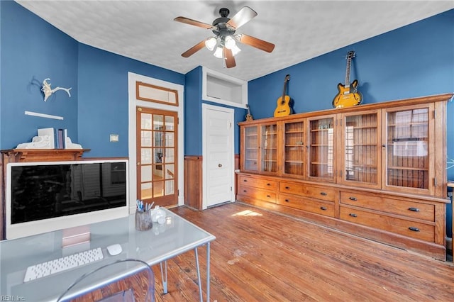 office area with wood-type flooring, a textured ceiling, and ceiling fan