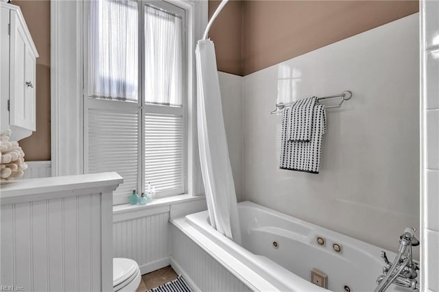 bathroom with tile patterned floors and toilet