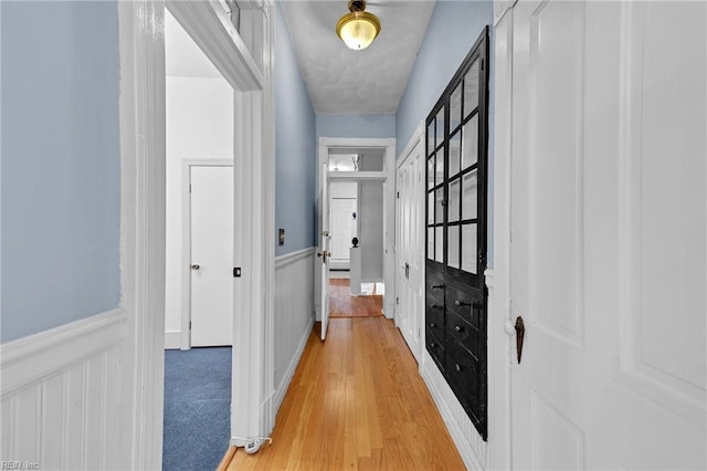 corridor with hardwood / wood-style flooring