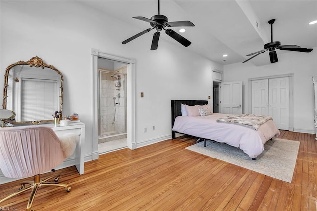 bedroom with connected bathroom, ceiling fan, and light hardwood / wood-style floors