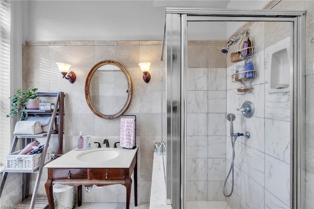 bathroom with a shower with door and sink