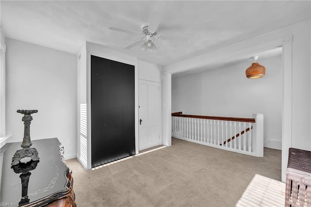 spare room with light colored carpet and ceiling fan