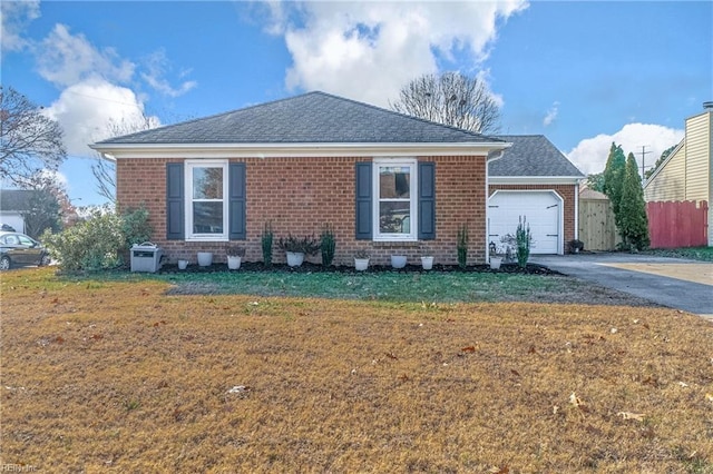 view of front of property featuring a garage and a front lawn