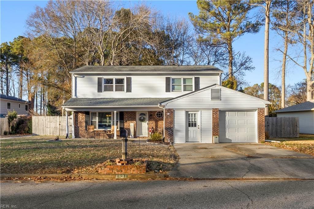 view of front property featuring a garage and a front lawn