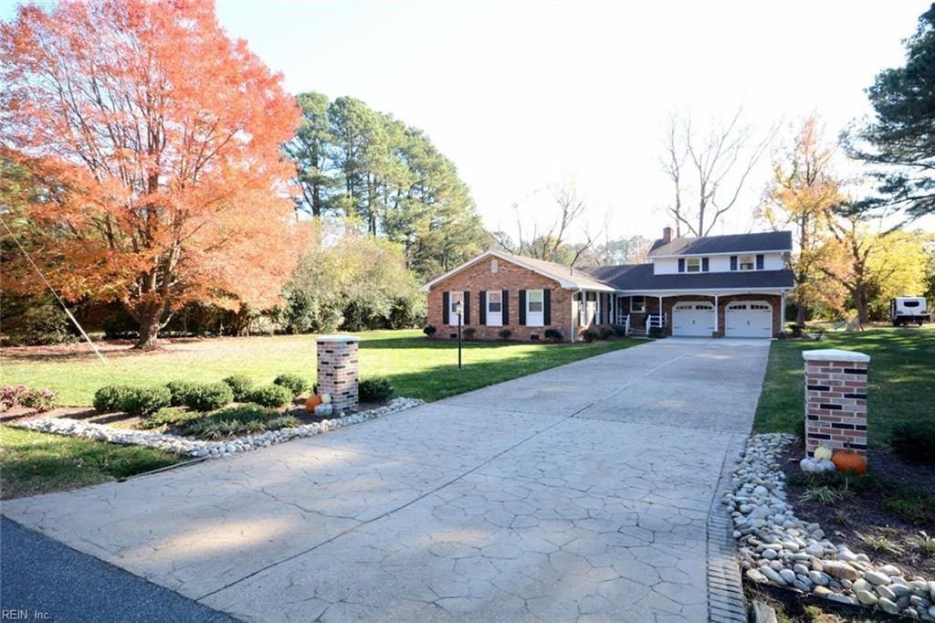 view of front of property featuring a garage and a front lawn