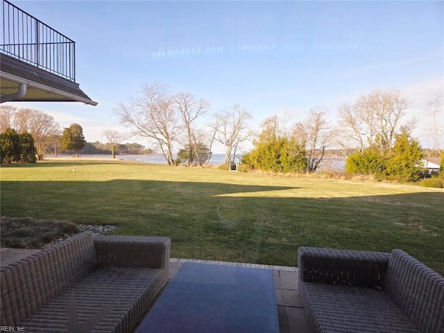 view of yard featuring a patio area and a water view