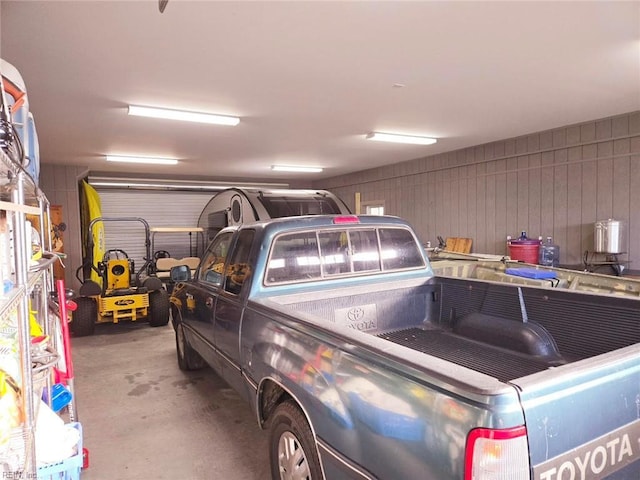 garage featuring wood walls