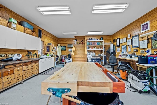 office with a workshop area and wood walls