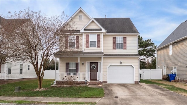 view of front of home featuring covered porch, a front yard, and a garage