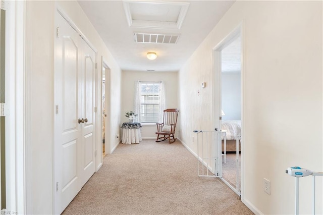 corridor featuring light colored carpet