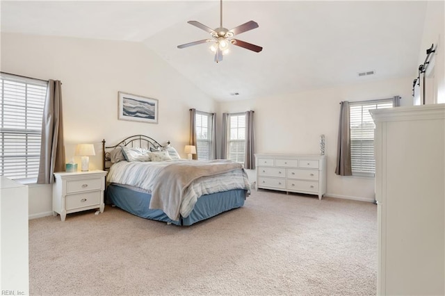 carpeted bedroom featuring ceiling fan, vaulted ceiling, and multiple windows