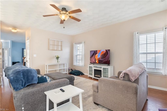 living room featuring ceiling fan, a healthy amount of sunlight, and hardwood / wood-style flooring